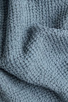 a close up view of a blue knitted fabric