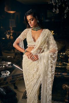 This ivory saree features all over three-dimensional embroidery. The blouse has a plunging neckline. The blouse sleeve hem shows pearl tassels. The saree comes with an optional veil.From Seema Gujral's Kashish collection DELIVERY TIMEPlease allow 8-12 weeks for your outfit to arrive. FABRIC DETAILSNet Professional cleaning only. Skirt Set Outfit, Pearl Tassels, Seema Gujral, Sabyasachi Sarees, Reception Saree, Sequin Saree, New Saree Blouse Designs, Punjabi Outfits, Elegant Outfit Classy