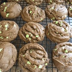 chocolate cookies with green sprinkles on a cooling rack