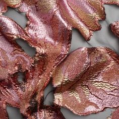 the fabric has been sequinized with gold and pink leaves on it, as well as metallic foil