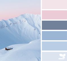 there is a house in the snow on top of a mountain with blue and pink hues