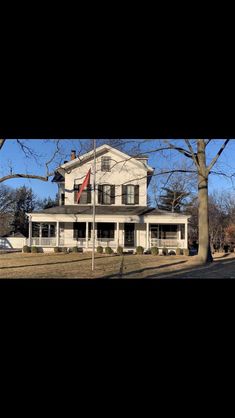 a large white house sitting on the side of a road