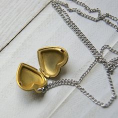 "A vintage brass heart locket hangs from a vintage stainless steel chain to make this simple and easy to wear necklace. The locket measures 7/8\" long and is NOS (new old stock) vintage with varying amounts of patina and scratches on the surface. Choose length at checkout: 16\". 18\". 20\". 22\". 24\". More heart jewelry can be found here: http://etsy.me/1Stzj2o To see more of my handmade jewelry in my Etsy shop, click this link: WearYourWild.etsy.com All jewelry comes nestled in recycled, rusti Vintage Heart-shaped Brass Necklace, Vintage Brass Heart Necklace, Dainty Brass Locket Charm Necklace, Vintage Heart Pendant Necklace With Adjustable Chain, Vintage Nickel-free Heart Necklace As Gift, Vintage Heart Locket Charm Necklace, Nickel Free Gold Open Heart Necklace, Gold Open Heart Nickel-free Necklace, Gold Open Heart Necklace Nickel-free