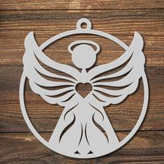 an angel ornament hanging on a wooden wall with a heart in the center