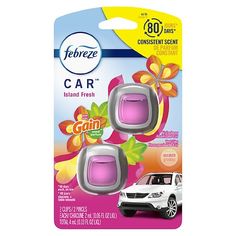 two pink car air fresheners in front of a white car