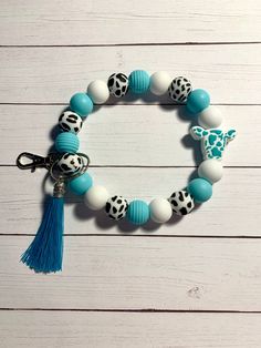 a blue and white beaded bracelet with a giraffe charm