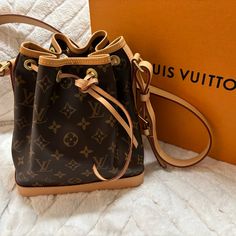 100% Authentic Louis Vuitton Monogram, Noe Bb Purse Practically Brand New Bought It In 2020 During Pandemic Never Worn It Has Been In The Dust Bag And Box Since I Got It It Is In Grate Condition Since I’ve Got It It Has Only Gone Up In Value Smoke And Pet Free Home Designer Monogram Canvas Bucket Bag For Daily Use, Chic Everyday Bucket Bag In Monogram Canvas, Chic Monogram Canvas Bucket Bag For Everyday, Monogram Canvas Pouch Bucket Bag For Shopping, Designer Daily Use Bucket Bag In Monogram Canvas, Canvas Bucket Bag For Shopping, Beige Signature Coated Canvas Bag With Dust Bag, Beige Signature Coated Canvas Bag With Dust Bag Included, Designer Monogram Canvas Bucket Satchel Bag