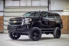 a black truck is parked in a garage