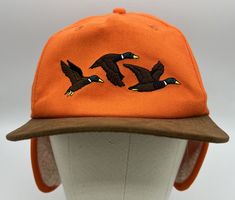 Brand New , In Factory Packaging, Genuine, The Good Company Seager Flap Jack Hat Orange Cap Duck design with toasty insulated flaps lined with organic sherpa, The stretchy elastic headband ensures a universal fit, adapting seamlessly to any size, making it an essential pick for anyone. blend of 60% acrylic, 20% wool, and 20% polyester (Exactly as shown) Save Now! Cap Design Ideas Hat, Flap Jack, 90s Hats, Jack Hat, Mens Hats Fashion, Best Caps, Elastic Headband, Vintage Clothing Men, Clothing Mockup