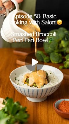 someone pouring sauce on top of a bowl of rice and broccoli in a bowl