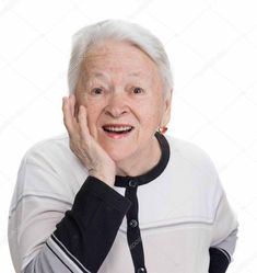 an old woman smiling and posing for the camera with her hands on her face stock photo