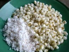 macaroni and cheese on a green plate next to white powdered sugar in a bowl