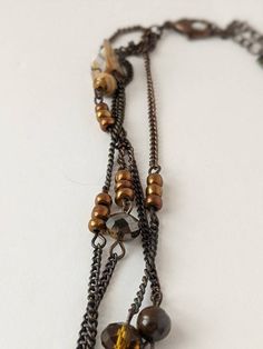 Beautiful vintage boho style necklace. Teardrop shaped tigers eye stone pendant with a filigree cutout copper-tone accent on top. The tigers eye has two small chips along the bottom but they're almost impossible to see. Strung on four antiqued bronze tone chains with pearl shell chips, crystal beads and copper colored faux pearls accents. Pendant measures 1.75 inches long. Necklace is 16 inches long with a lobster claw clasp and 3 inch adjustable chain. Shop Policies: Shipping: All items will be Brown Bohemian Teardrop Pendant Jewelry, Bohemian Brown Teardrop Pendant Jewelry, Brown Metal Dangle Necklaces, Bronze Metal Necklaces With Natural Stones, Bronze Metal Necklace With Natural Stones, Bronze Necklaces With Natural Stones, Bohemian Metal Teardrop Necklace, Bohemian Teardrop Metal Necklace, Bohemian Brown Metal Necklace