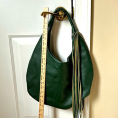 “B-Low The Belt”, Dark Green Genuine Leather, Pristine Condition Inside And Out, Large Shoulder Bag With Tassels. Has Inside Zipper And Slip Pocket. Magnetic Closure. Very Unique, One-Of-A Kind. Green Bucket Shoulder Bag With Handle Drop, Green Leather Hobo Bag With Handle Drop, Green Leather Bucket Hobo Bag, Green Hobo Bag With Handle Drop For Errands, B Low The Belt, Hobo Style, Belt Bags, Large Shoulder Bags, Leather Hobo