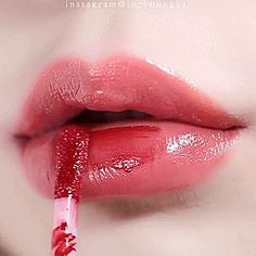 a woman's lips are painted with red lipstick