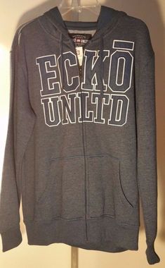 New with Tags  Ecko Unltd. "Branded Hood Hoodie Holiday 2" Men's Zip-up Hoodie Zip-up front 80% cotton 20% polyester Two hand pockets Lined hood with a draw cord Wide elastic bands at waist and sleeve hem Soft fleece inside Logo/brand emb work front Fall Cotton Hoodie With Logo Print, Urban Cotton Hoodie With Zipper Closure, Casual Cotton Outerwear With Logo Print, Cotton Sweatshirt With Zipper Closure, Urban Cotton Outerwear With Logo Print, Gray Cotton Sweatshirt With Zipper Closure, Winter Cotton Outerwear With Branding, Hoodie Zip, Zipper Hoodie