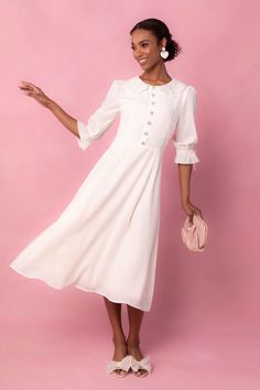 The Ruth Dress showcases a sheer material with a delicate lace peter collar detail. Her fit and subtle flare silhouette adds a touch of elegance, while the tea length provides a timeless look. The non-functional buttons on the bodice are charming and feminine, and the sophisticated cream color complete the design. Ivy City Women's Ruth Dress | Size: 14 Ivy City Co, Pom Pom Dress, Lover Dress, Shower Outfits, Modesty Outfits, Bridal Jumpsuit, City Woman, Bridal Shower Dress, Heart Dress