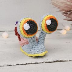 a crocheted toy with two eyes on it