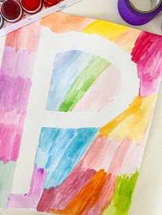 the letter d is painted with watercolors and crayons