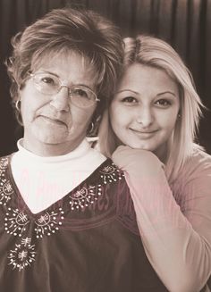 two women are posing for a black and white photo with their arms around each other