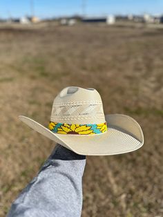 Add a touch of nature to your hat with our Sunflower Hatband. Handcrafted with intricate sunflower beads, this hat band is the perfect accessory for any outdoor excursion. The black leather ends add an extra 11 1/2 inches, providing a comfortable and secure fit. The whole hat band measures 30 1/2 inches, making it versatile for all hat sizes. Ballcaps For Women Outfit, Adjustable Natural Hat Band For Rodeo, Natural Color Adjustable Western Hat Bands, Adjustable Natural Color Western Hat Band, Adjustable Western Hat Band In Natural Color, Adjustable Natural Western Hat Bands, Adjustable Brimmed Sun Hat For Ranch, Adjustable Hat Bands For Country Events In Spring, Adjustable Natural Hat Band For Outdoor