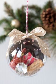 an ornament hanging from a christmas tree filled with candies and other treats