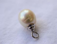 The size of the South Sea pearl is approximately 11.5mm. The pearl is teardrop shape, has a silver, very light pink overtone with high luster. The top of the bail to the bottom of the pearl is approximately 7/8 inch long. It comes with a 16 inch 14K white gold chain. Please visit our shop policies for more details! All items are in stock and ready to ship as soon as I have received payment. For more information, Like us on Facebook, follow us on Instagram or visit our website www.ikedapearl.com White Gold Teardrop Pearl Necklace With Charm, White Gold Drop Pearl Necklace, Classic Teardrop White Gold Pearl Necklace, Classic White Gold Teardrop Pearl Necklace, White Gold Teardrop Pearl Necklace, White Gold Pearl Charm Necklace, White Gold Pearl Necklace With Pear-shaped Charm, Pear-shaped White Gold Pearl Necklace With Charm, White Gold Pear-shaped Pearl Necklace With Charm