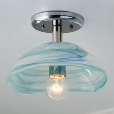 a light fixture with a glass shade on the bottom and an electric bulb attached to it