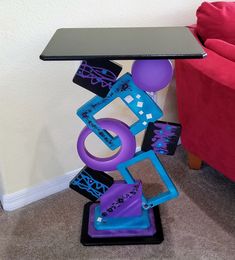 a table that has some kind of art on it with purple and blue items around it