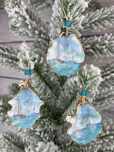 three ornaments hanging from a christmas tree