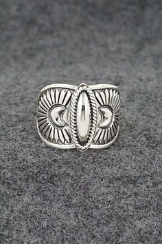 This finely crafted sterling silver ring was made by Navajo silversmith Derrick Gordon. The back is signed Derrick and stamped sterling.Size: 9.5Length: 5/8"Free shipping on all orders! We ship with USPS and always include tracking. All orders ship within a day of payment.Returns are accepted up to 30 days after you receive your order. Just send us a message. Our shop offers cash back or store credit. The item must be returned in new condition. Western Style Sterling Silver Rings In Silver, Handmade Silver Western Style Rings, Western Style Sterling Silver Rings, Handmade Western Silver Rings, Artisan Silver Ring With Concho, Silver Bohemian Concho Rings, Bohemian Silver Concho Rings, Western Sterling Silver Concho Rings, Western Style Sterling Silver Concho Rings