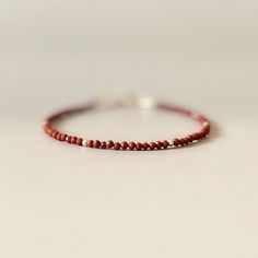 Introducing this extra dainty 2mm red jasper bracelet, made of genuine gemstones. Features: -Delicate, dainty design, 2mm (appears larger in photos due to close up view) -14k gold filled or sterling silver accents and components -Perfect for stacking or by itself, timeless design, will complement but not overpower any outfit -Boho minimalist jewelry style - It will come in a gift-ready branded storage pouch with a cleaning cloth Gifting Ideas: -Any occasion gift for a mother, friend, girlfriend, Red Jasper Bracelet, Outfit Boho, Jasper Jewelry, Friend Girlfriend, Boho Minimalist, Gifting Ideas, Jasper Bracelet, Bracelet Dainty, Crystal Beads Bracelet