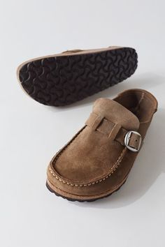 Semi-open, moccasin-style clog made instantly recognizable as an authentic Birkenstock original thanks to its exposed cork footbed. Upper is made from soft, suede leather, with an adjustable metal pin buckle. Anatomically-shaped cork-latex footbed, color-coordinated suede lining and lightweight EVA sole. Content + Care Leather, cork, EVA Spot clean Imported Size + Fit True to size | Birkenstock Buckley Suede Moccasin Clog in Grey Taupe at Urban Outfitters Suede Slip-on Clogs With Buckle Closure, Birkenstock Buckley, Moccasins Style, Suede Moccasins, Eva Sole, Metal Pins, Soft Suede, Moccasins, Suede Leather