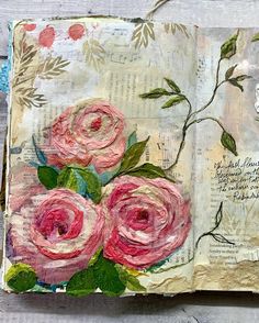 an altered book with pink roses on it