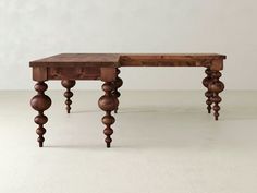 a wooden table sitting on top of a white floor