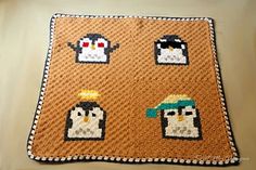 a crocheted blanket with penguins on it