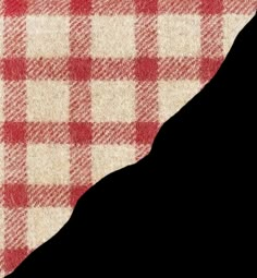 a red and white checkered table cloth on top of a piece of paper that is torn in half