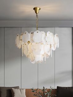 a chandelier hanging from the ceiling in a living room