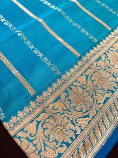 SILK MARK CERTIFIED !!Gorgeous Pure Katan Turquoise Color with undertone of Blue with Copper and Slier Zari Work. Strips Sarees in Copper and Sliver Zari with Floral Buttas on the Pallu Soft, light weight and easy to drape Saree. The Strips are dense towards the pallu and get scattered the other end. Item : SareeColor : Turquoise Color with undertone of BlueBase Fabric : Pure Katan Silk Blouse piece : Comes with Blouse pieceBlouse material : Pure Katan SilkFall & Edging (Yes/No) : YesComes with Banarasi Katan Silk Saree, Katan Silk Saree, Men's Ethnic Wear, Drape Saree, Bandhani Saree, Katan Silk, Kanjivaram Sarees, Readymade Blouse, Zari Work