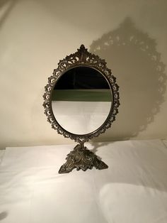 a mirror sitting on top of a white sheet