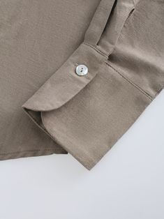 Enhance your summer wardrobe with our Linen Blouse-Olive. The loose fit and relaxed design will keep you looking stylish while keeping you cool. Perfect for any casual or formal occasion. Casual Beige Tops With Roll-up Sleeves, Khaki Cotton Tops For Work, Classic Cotton Blouse In Neutral Color, Classic Neutral Cotton Blouse, Khaki Cotton Top With Roll-up Sleeves, Unstructured Khaki Top For Work, Unstructured Khaki Tops For Workwear, Neutral Cotton Button-up Blouse, Neutral Button-up Cotton Blouse