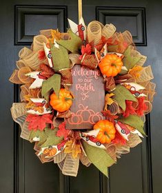 a welcome fall wreath hanging on the front door