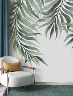 a white chair sitting in front of a wall with green leaves on it's side