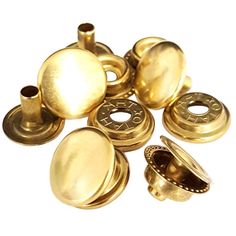 brass plated metal buttons and knobs on a white background