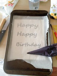 a birthday cake with an umbrella on it sitting on a table next to other items