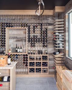 a wine cellar filled with lots of bottles and wooden shelves next to a counter top