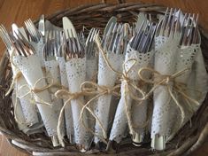 a basket filled with silverware sitting on top of a wooden table