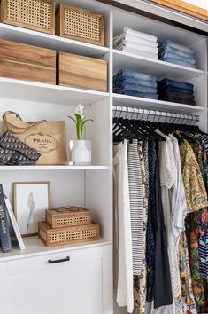 an organized closet with clothes and baskets