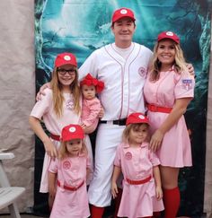 a baseball player poses for a photo with his family