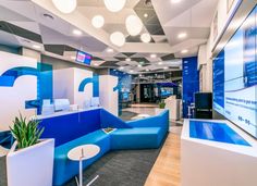 an office lobby with blue and white furniture